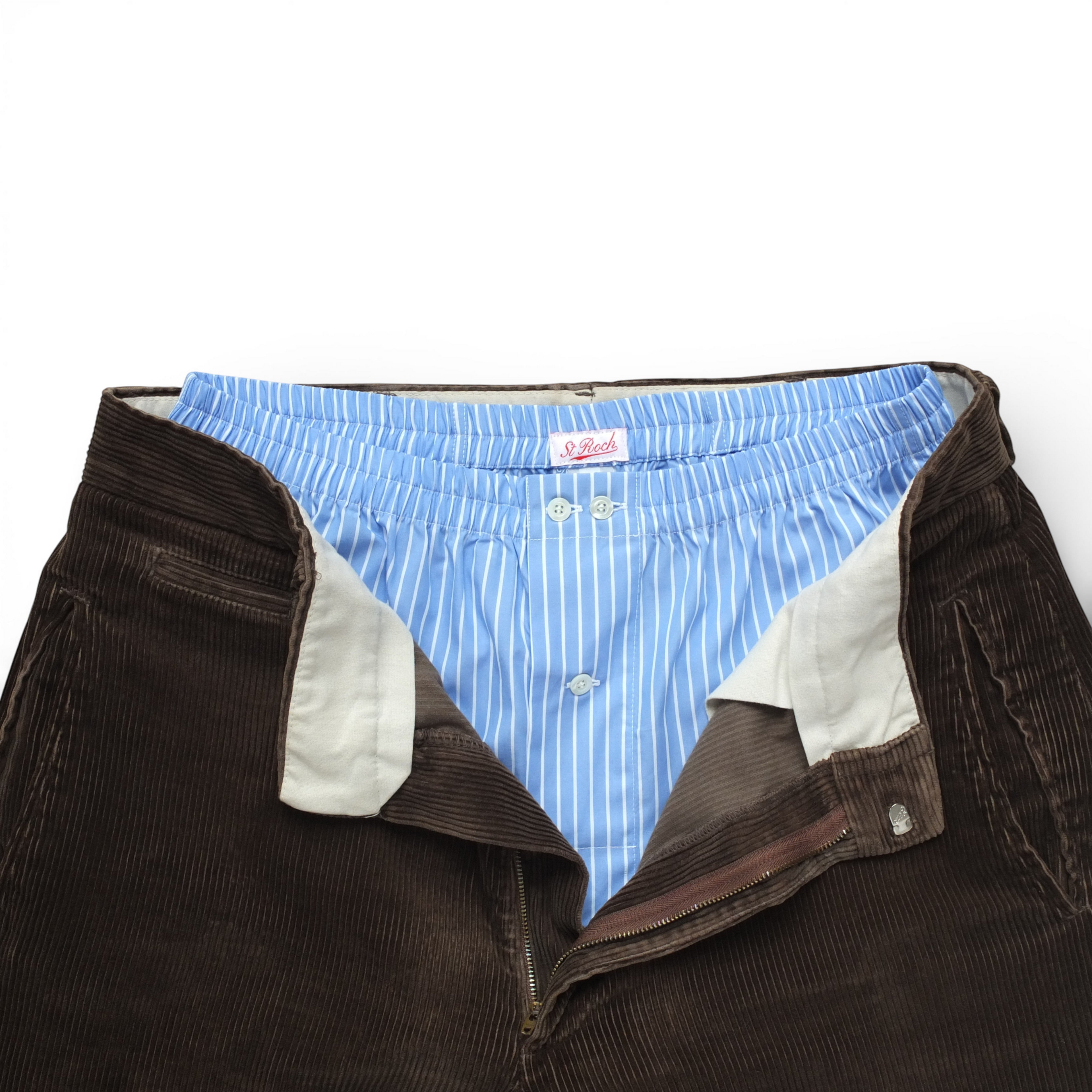 St Roch light blue and white striped poplin boxer shorts with a button fly, shown with brown corduroy trousers.